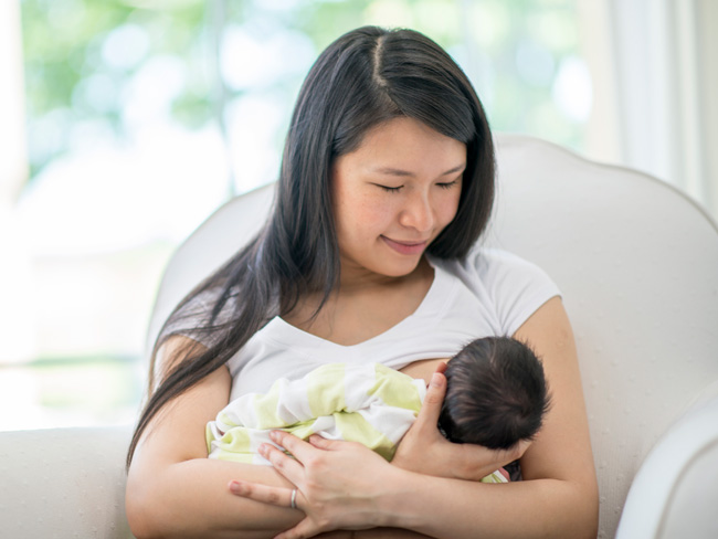 mother breastfeeding her newborn son